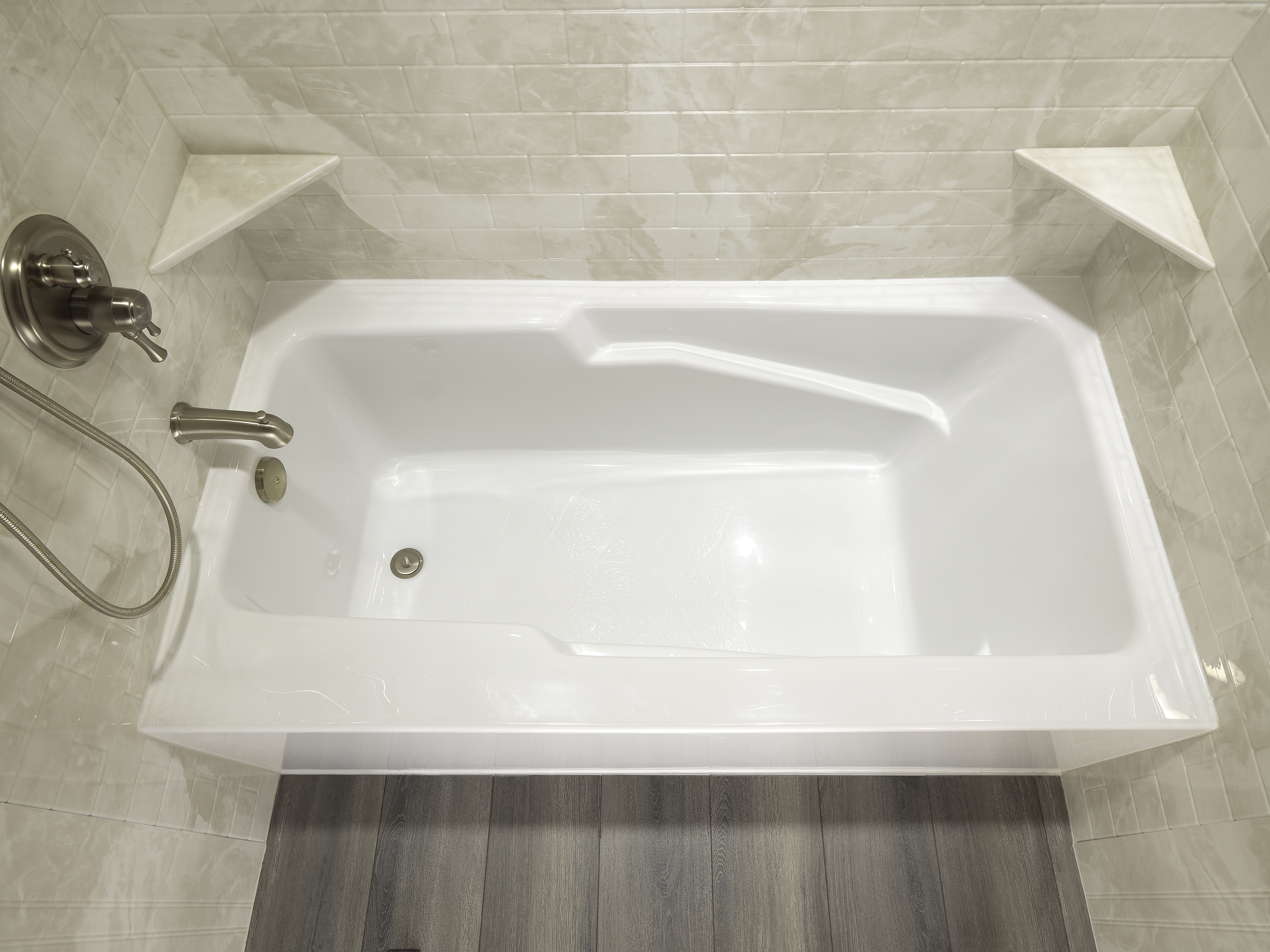 Deep white soaker tub with brushed nickel fixtures